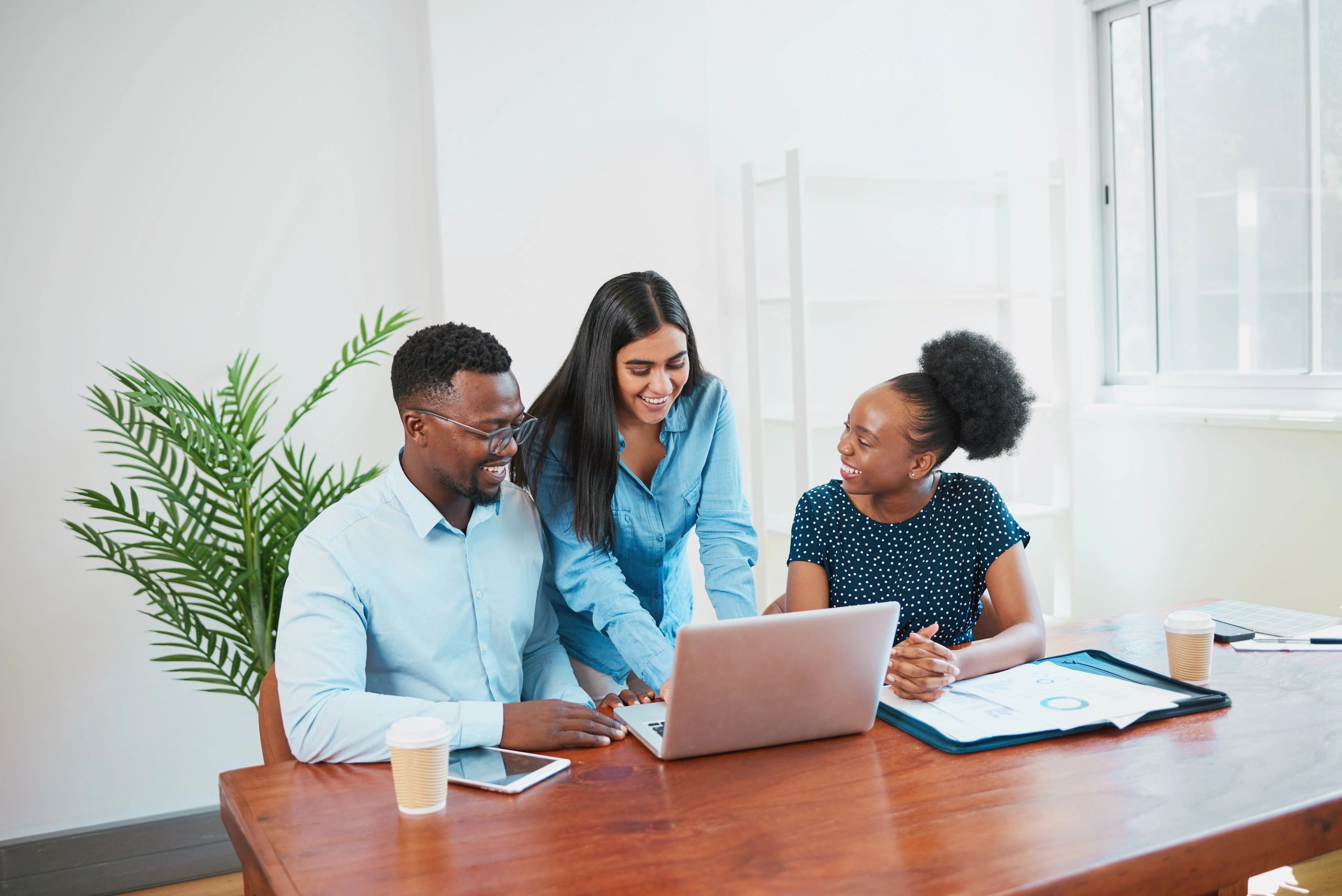 Business team reviewing communication strategy on a laptop