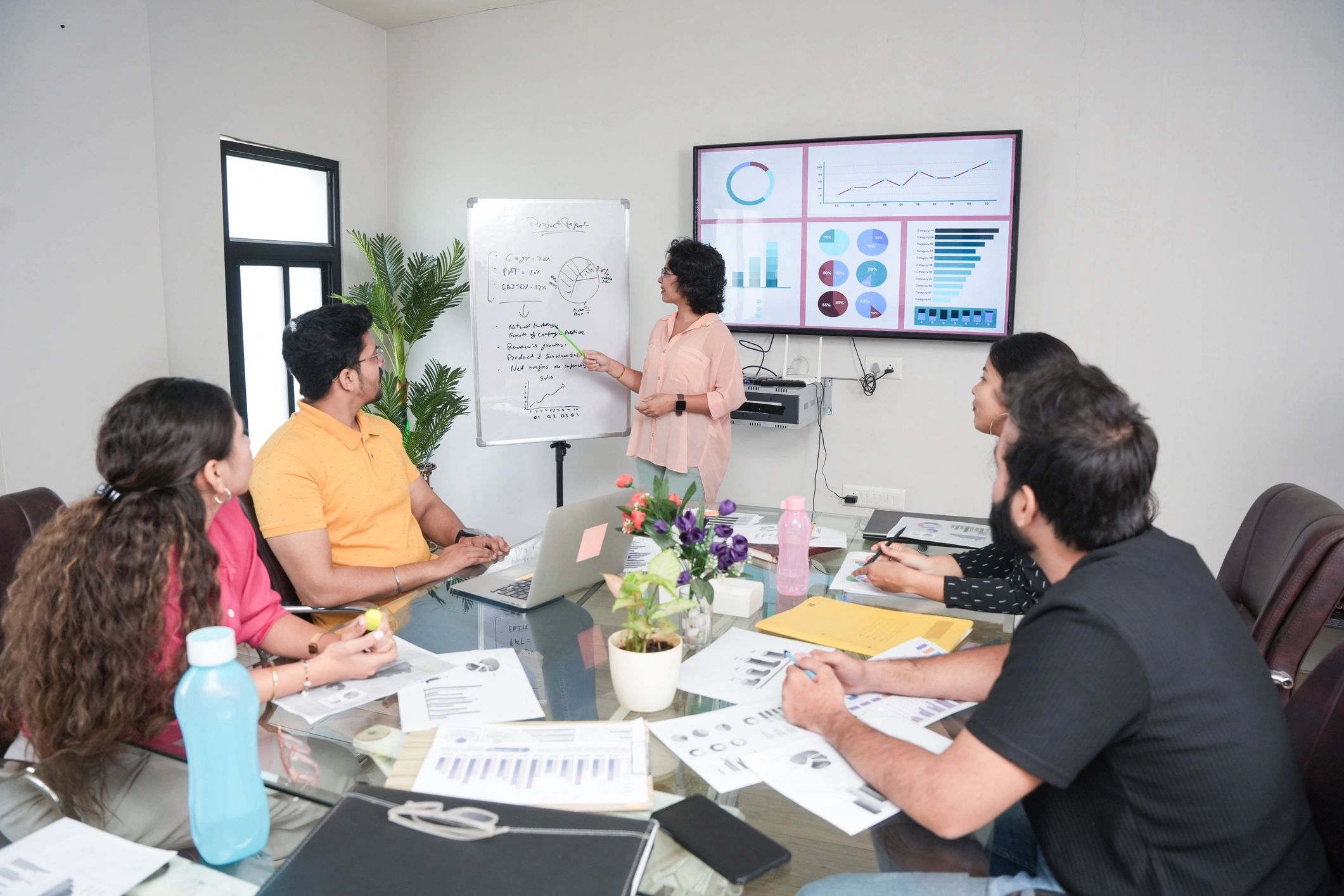 Marketing consultant presenting strategy to a team in a modern office